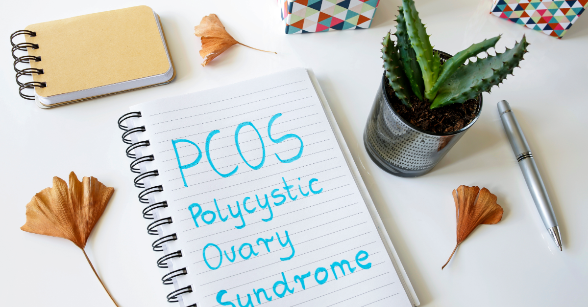 PCOS Polycystic ovarian syndrome written in a notebook on white table