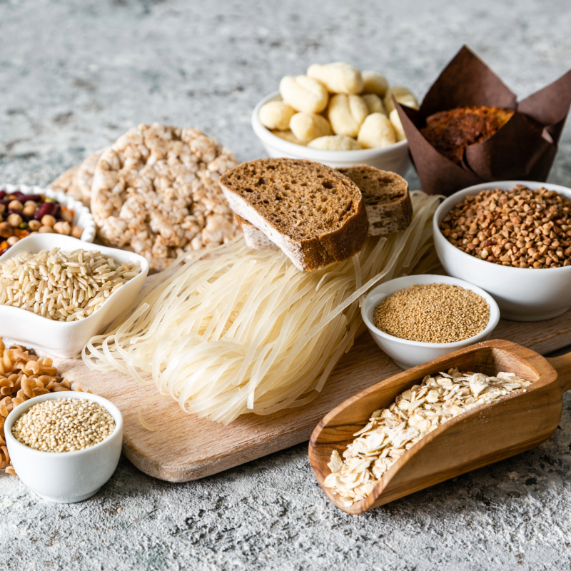 bread, pasta, oats on a table and cutting board